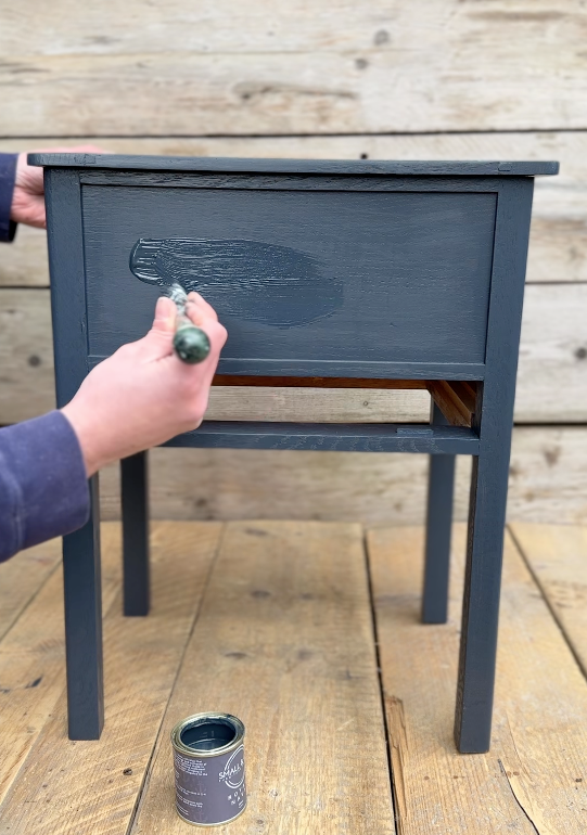 Painting second coat of chalk-style furniture paint on wooden side table using Small & Co brush, step-by-step beginner tutorial for even finish and durability