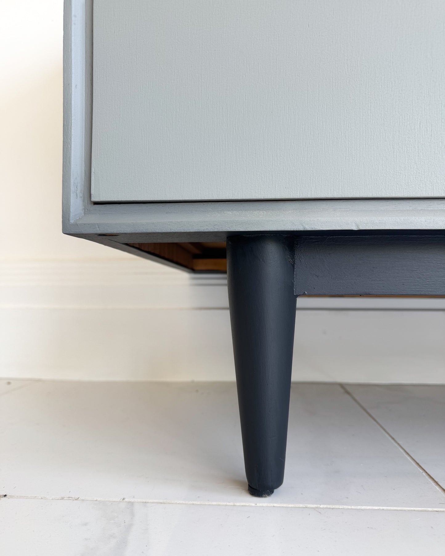 Detail of sideboard leg painted in Highland Haze grey furniture paint by Small & Co with darker contrasting base – durable finish for furniture restorations.
