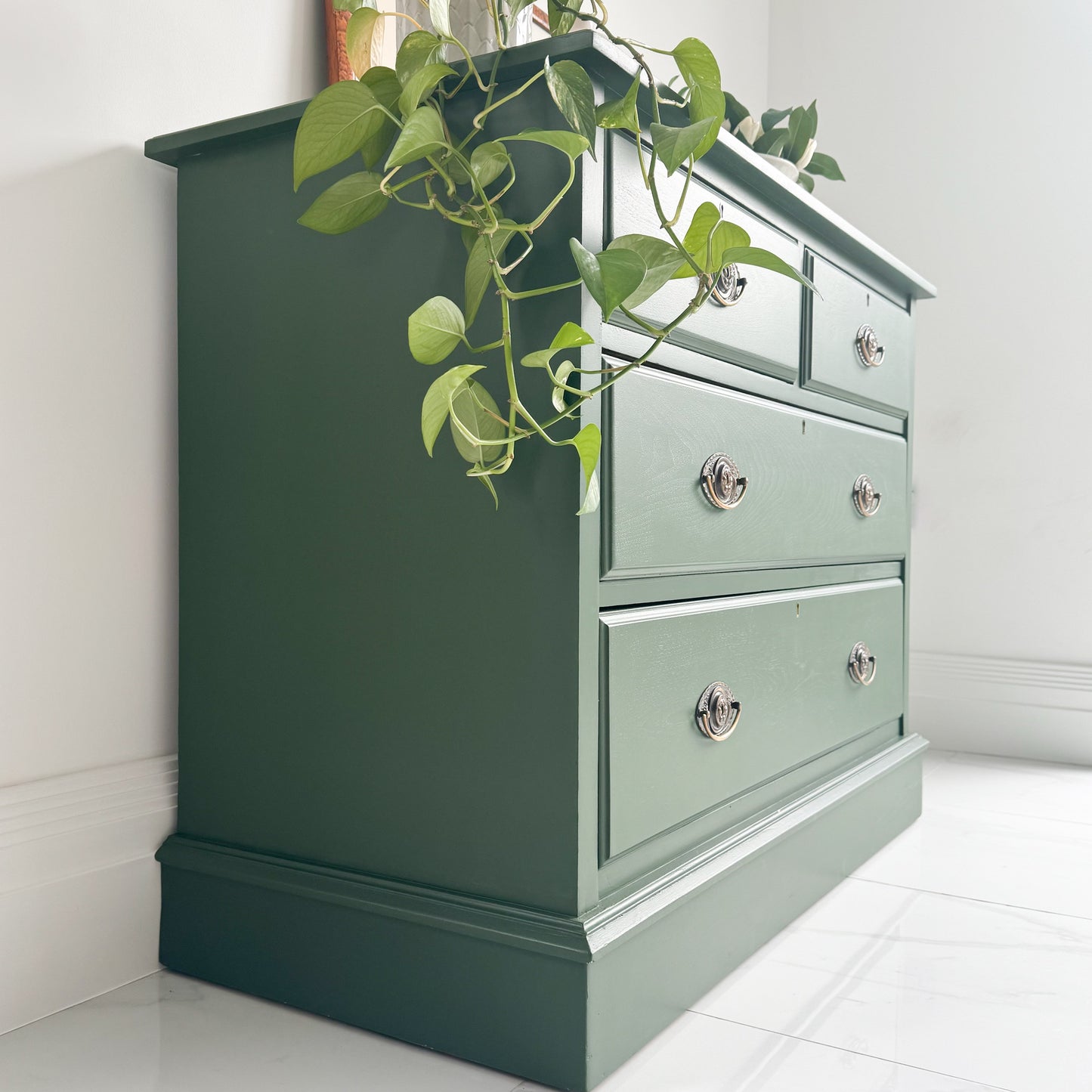 side on view of a victorian chest of bedroom drawers painted in a deep green called Dartmoor Deep by small and co furniture paints