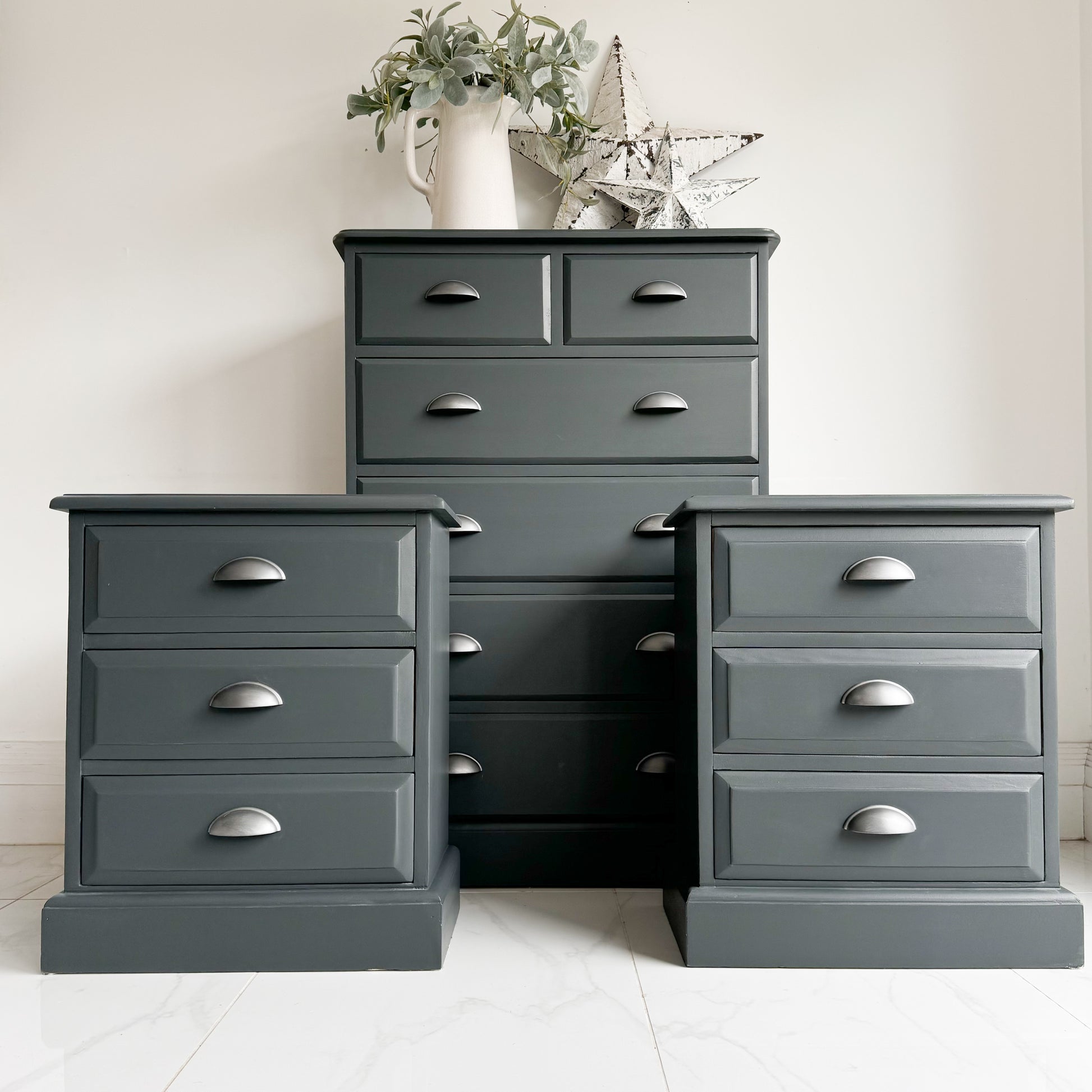 Iron Bridge colour by Small and co Furniture Paints, a dark charcoal grey near black tone painted on a bedroom set of chest of drawers and bedside tables