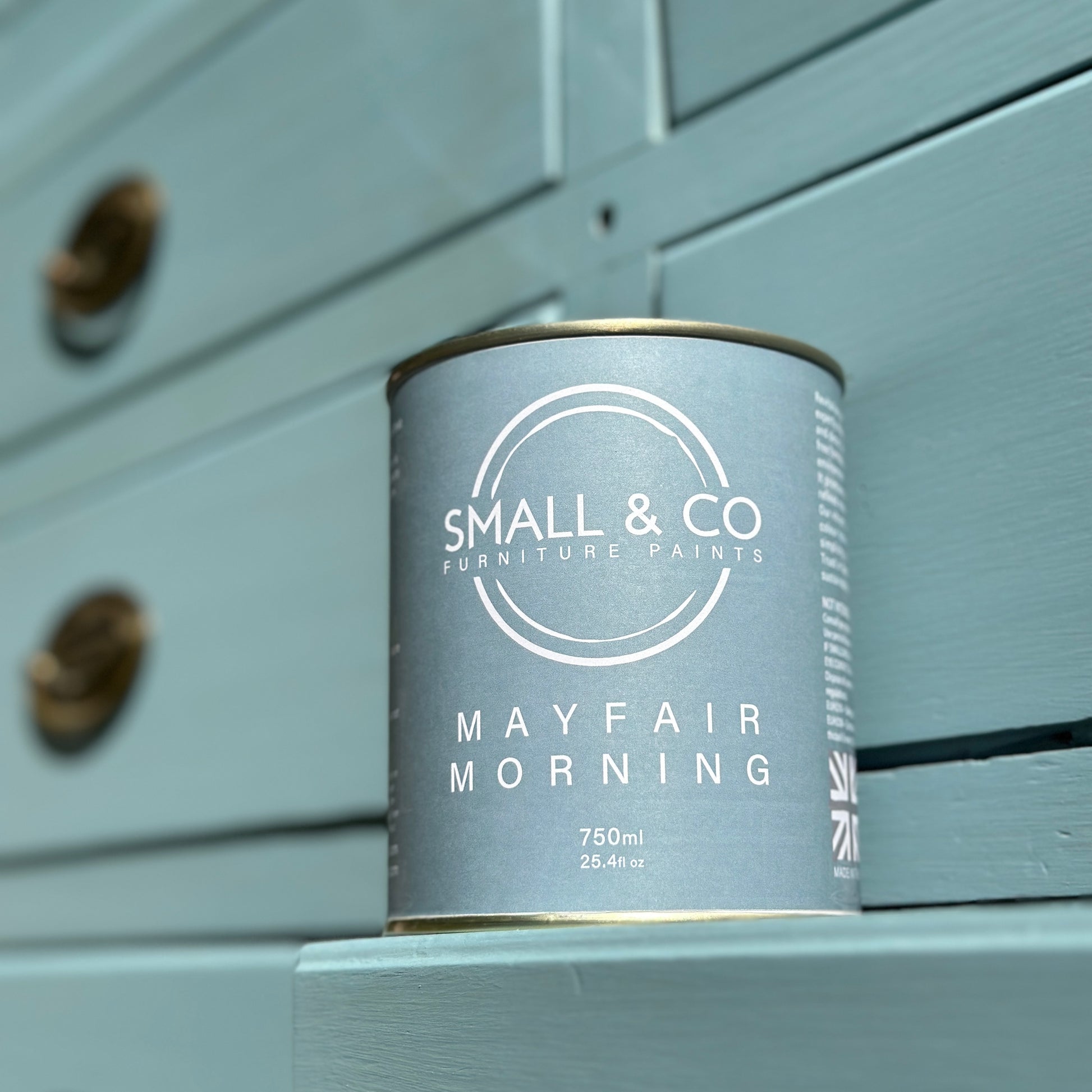 Mayfair Morning Vibrant Sky Blue Furniture Paint Colour with 750ml tin next to a painted Georgian linen cupboard