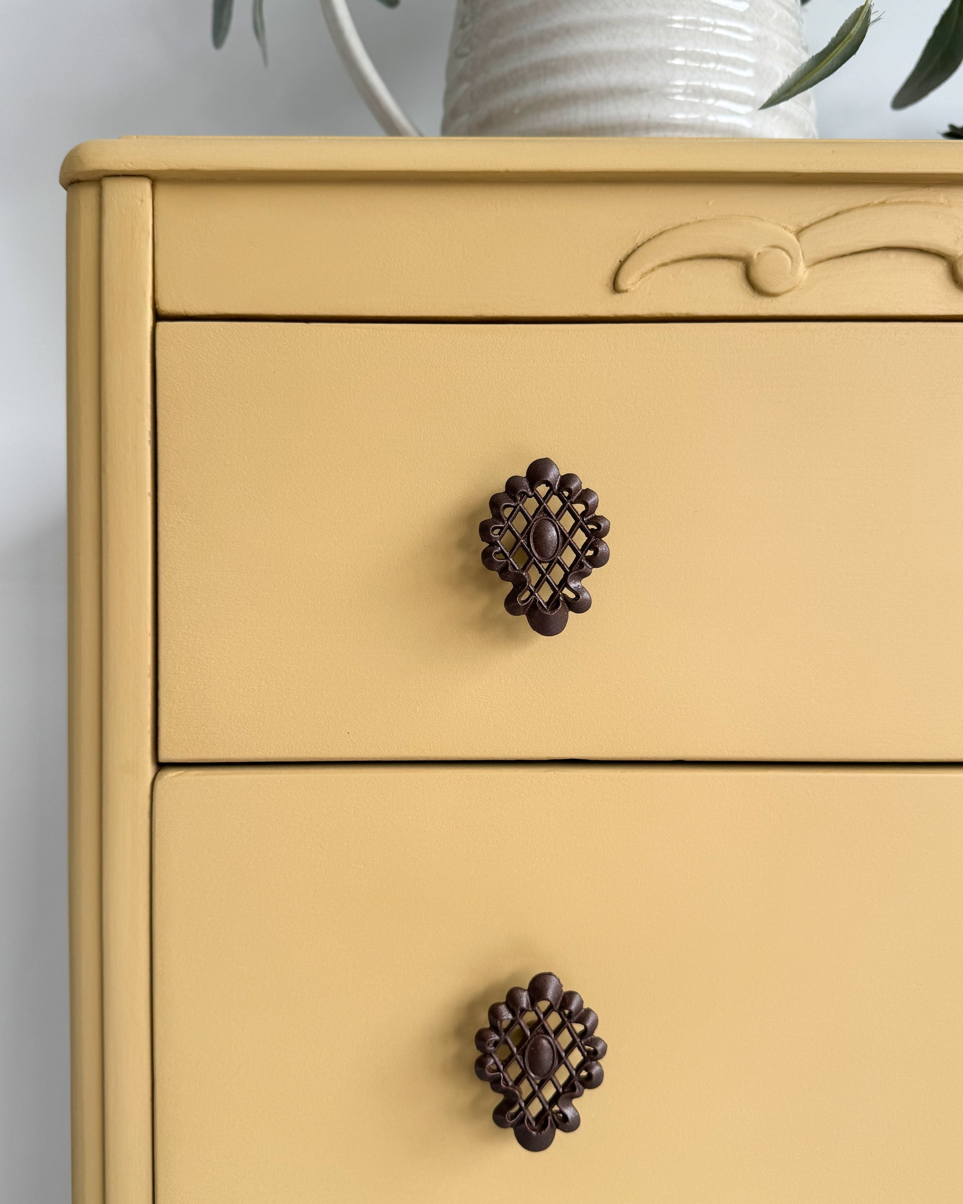Close-up of ornate trim on furniture painted in English Mustard, a deep yellow chalk-style paint from Small & Co, ideal for DIY home décor and upcycled vintage furniture.