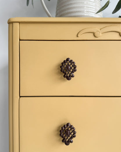 Close-up of ornate trim on furniture painted in English Mustard, a deep yellow chalk-style paint from Small & Co, ideal for DIY home décor and upcycled vintage furniture.