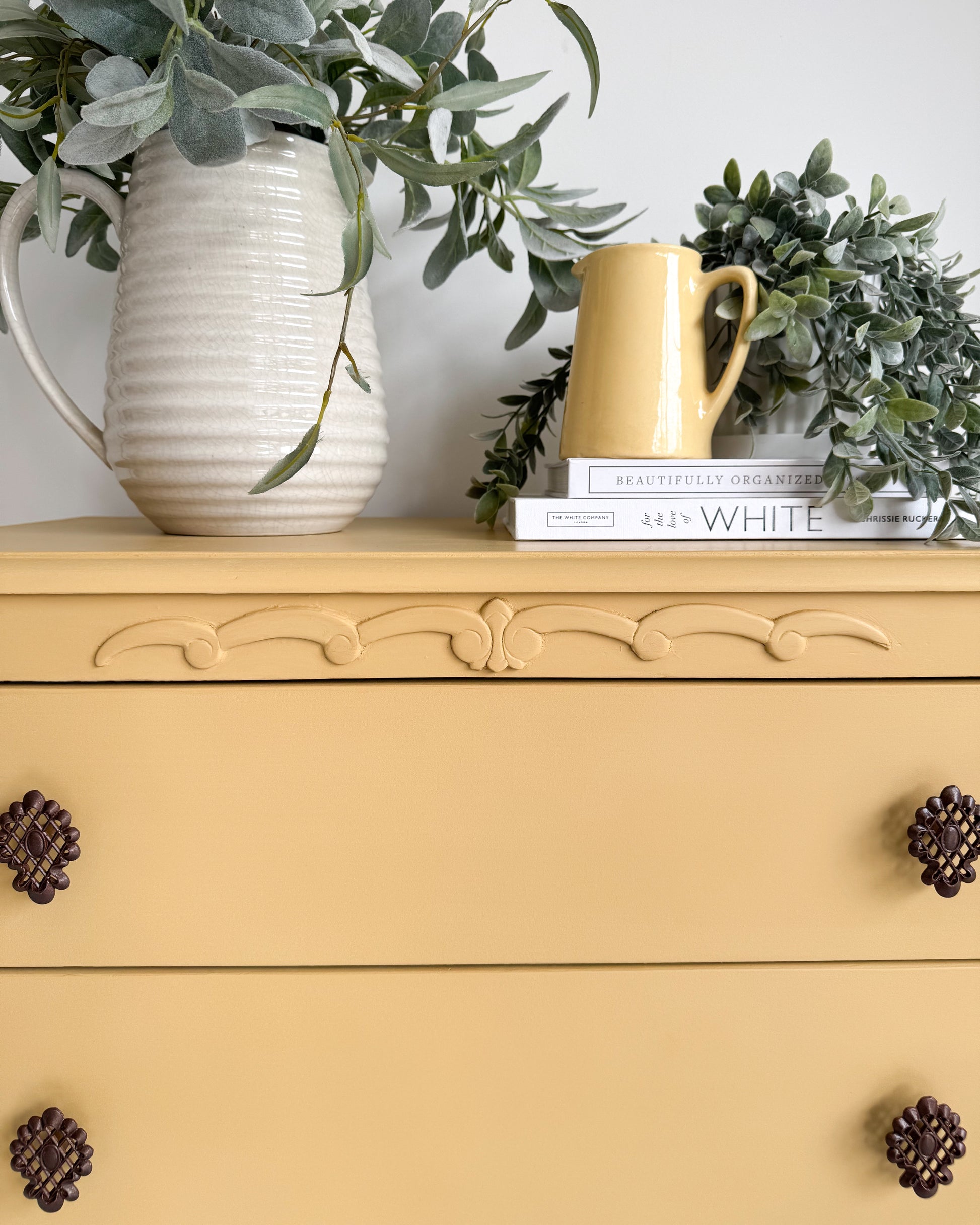 Close-up of decorative vintage knobs on furniture finished with Small & Co’s English Mustard yellow paint – a bold matte finish for modern and rustic interiors
