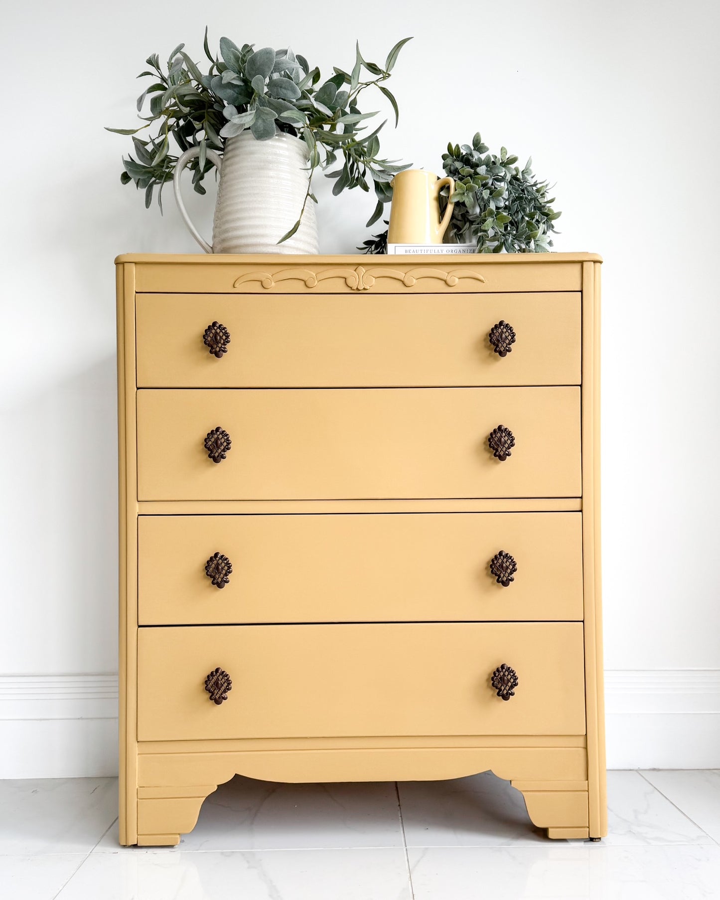Vintage chest of drawers painted in English Mustard by Small & Co Furniture Paints, styled with greenery and ceramic jugs – perfect for mustard yellow painted furniture inspiration.