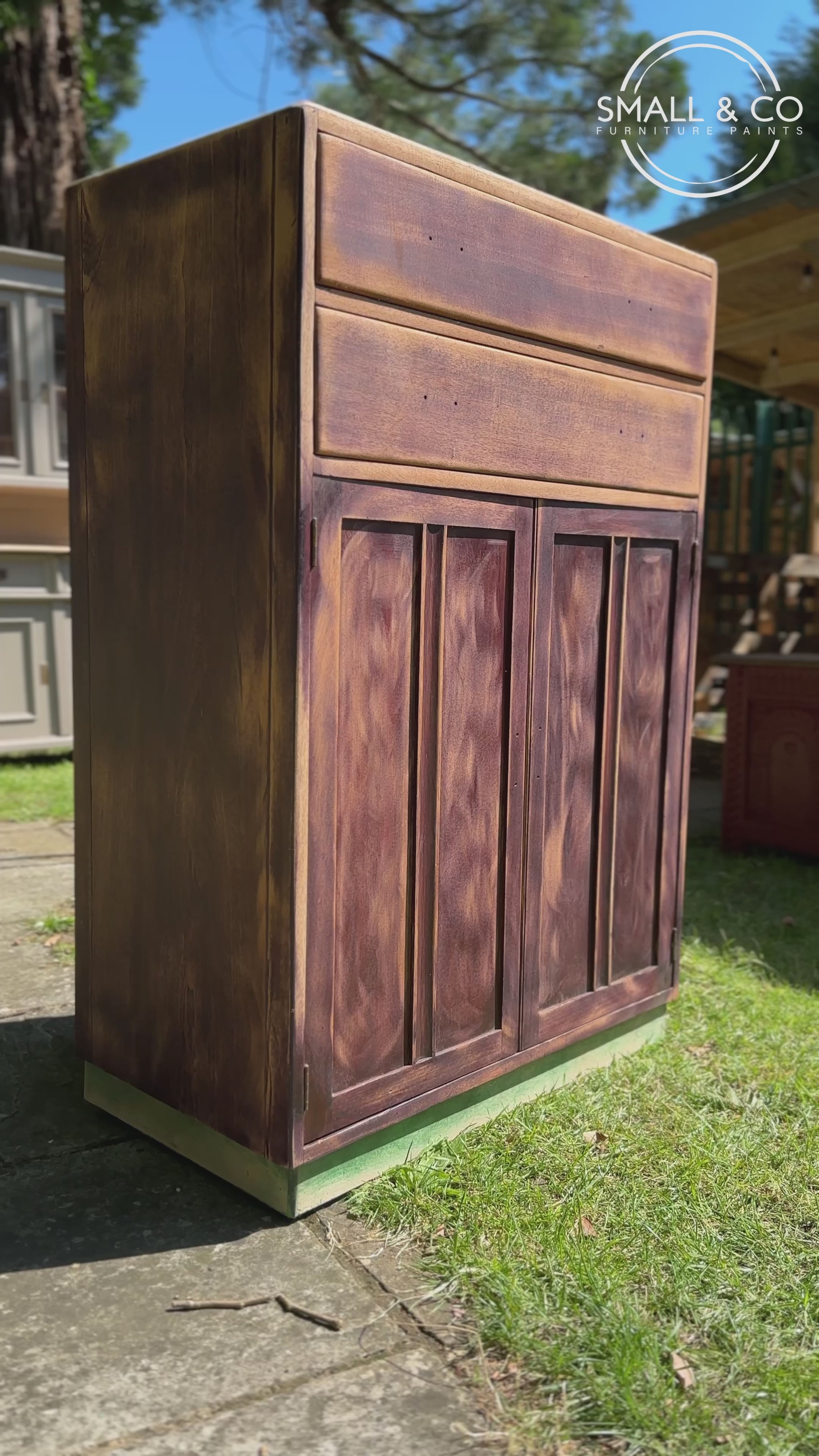 vintage retro mid century tallboy cupboard being painted in small and co sussex brick, an orange peach toned terracotta red colour, hand painted in the UK by UK made paints