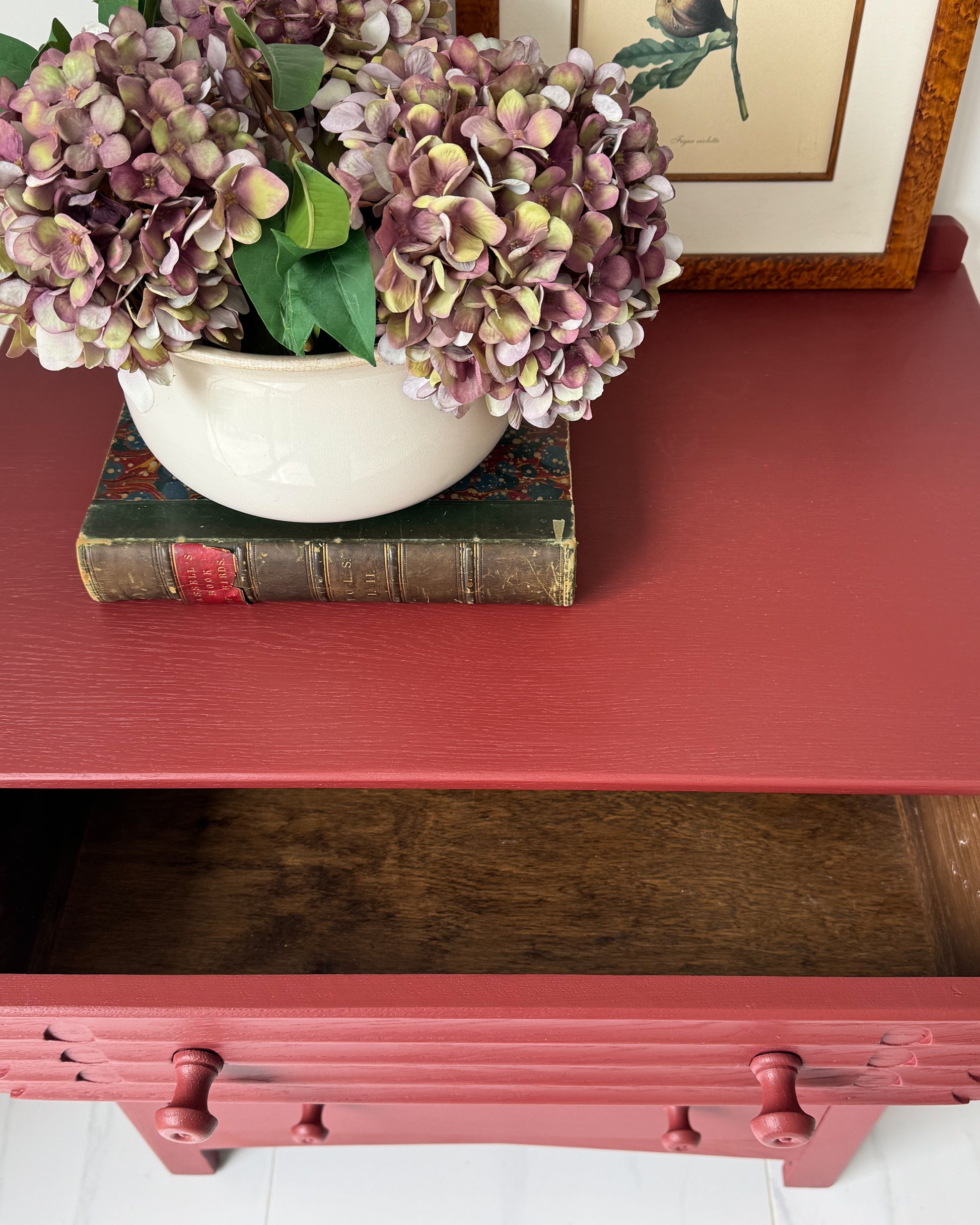 Bedroom storage chest painted in Small & Co Cricket Leather red eco-friendly paint, styled with vintage decor accents