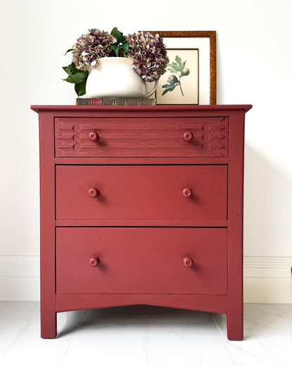 Vintage wooden chest of drawers painted in Small & Co Cricket Leather red furniture paint, showing rich durable finish